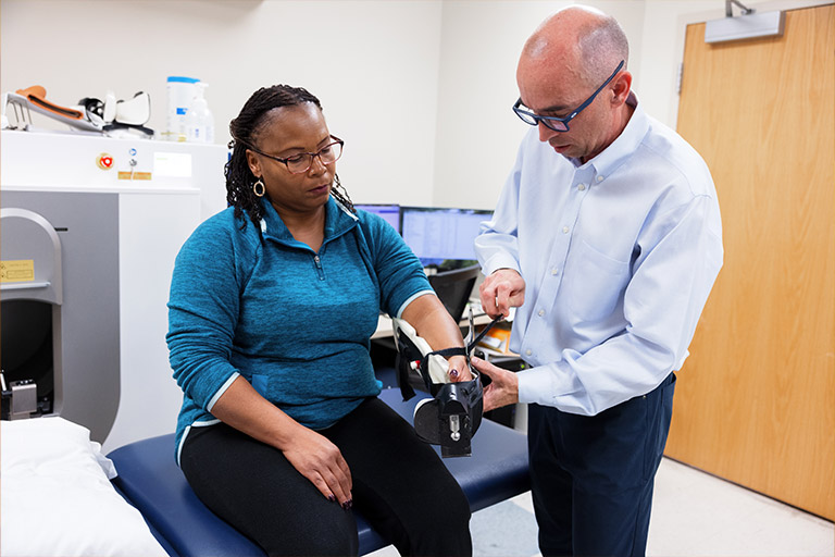 A doctor applying an arm brace to a patient.