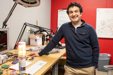 Portrait of Amrou Awaysheh smiling at the camera.