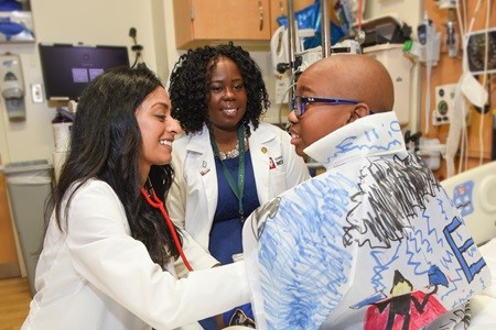 Seethal Jacob with a sickle cell patient at Riley.